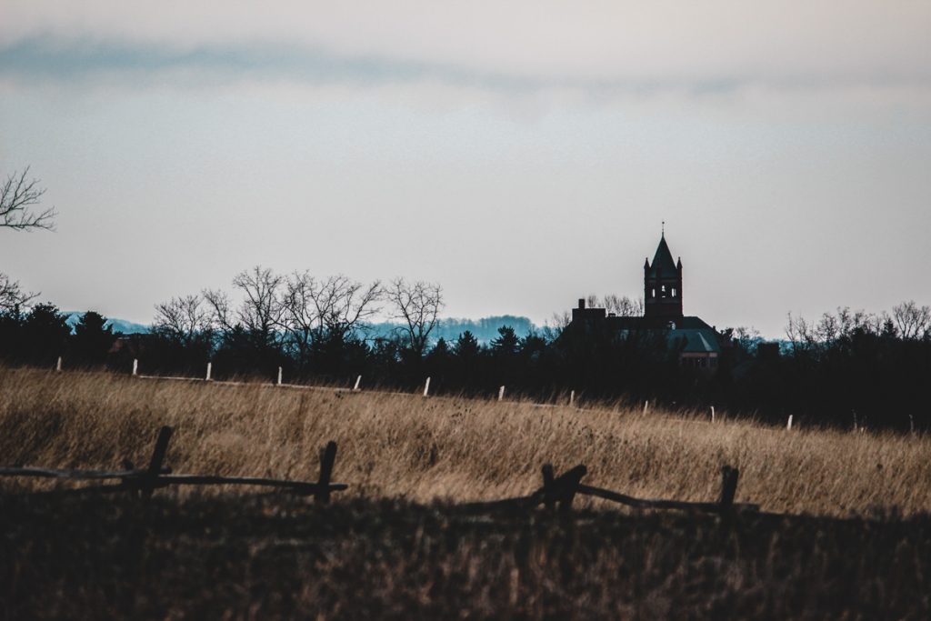 Church in distance, looking over a battlefield in Gettysburg.
