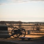 Gettysburg battlefield with cannon and stone monument